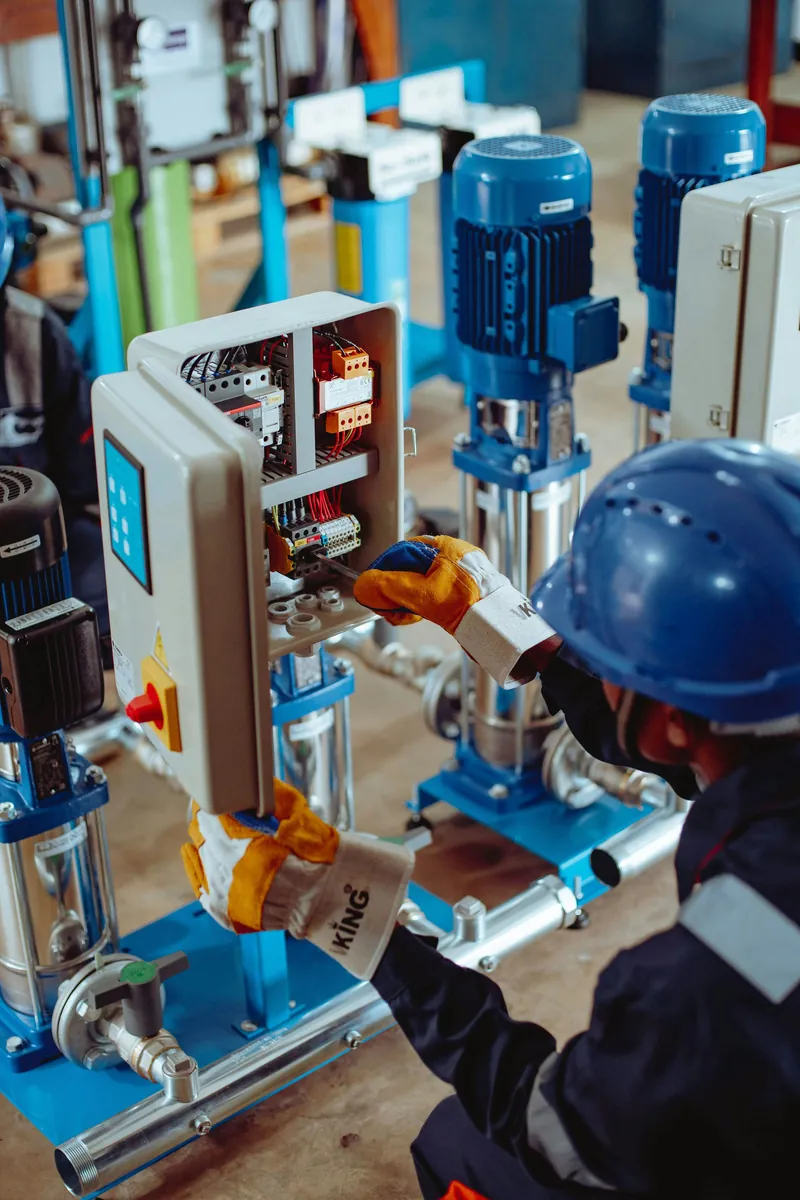 Technician servicing electromechanical equipment